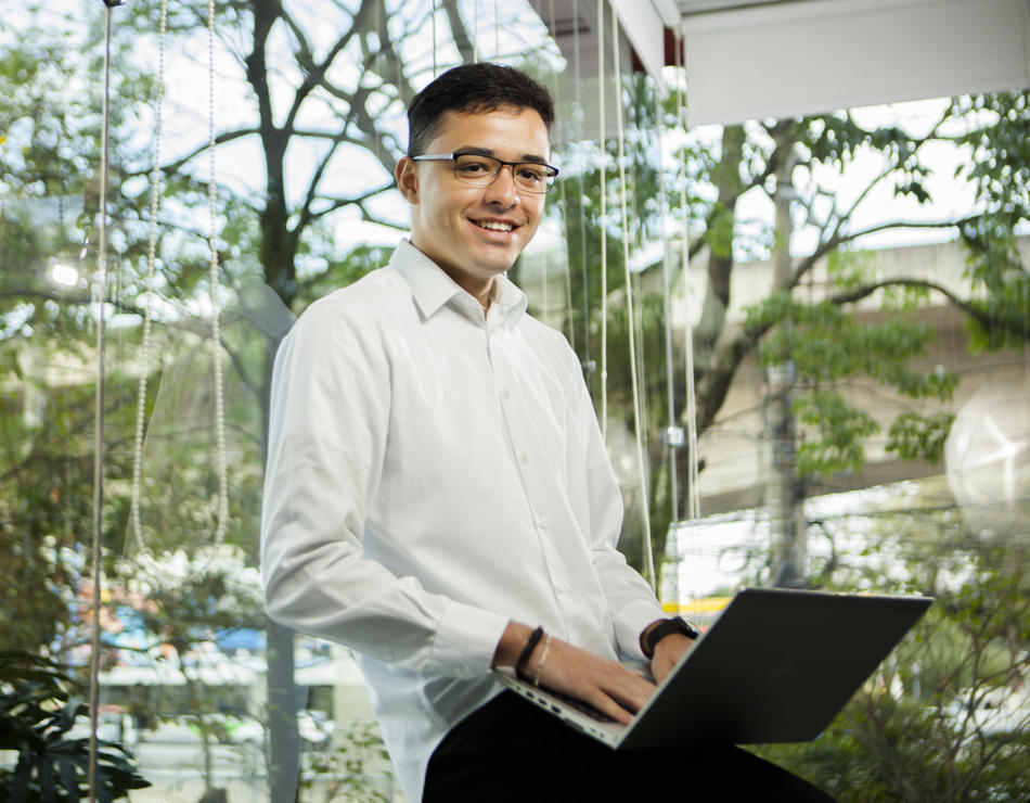 a person sitting on a chair with a laptop