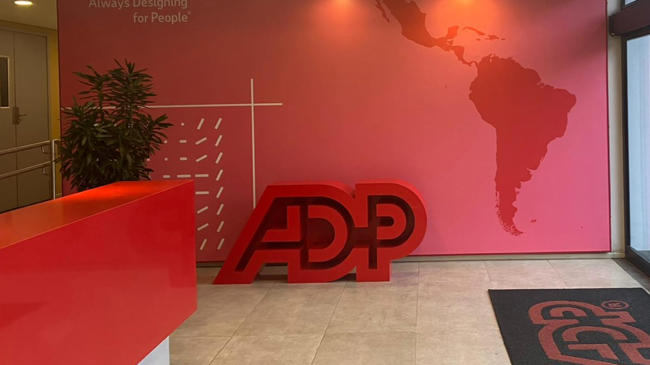 a pink reception desk with a large red sign