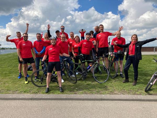 a group of people in red shirts posing for a photo