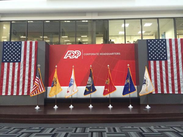 flags on a stage with a red and white banner