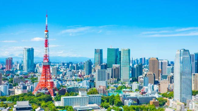a tall red and white tower in a city
