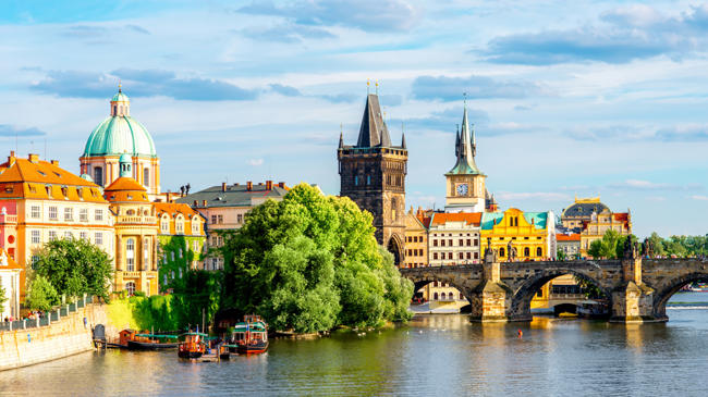 a river with a bridge and buildings