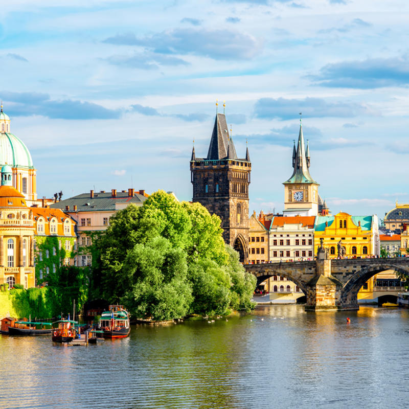 a river with a bridge and buildings