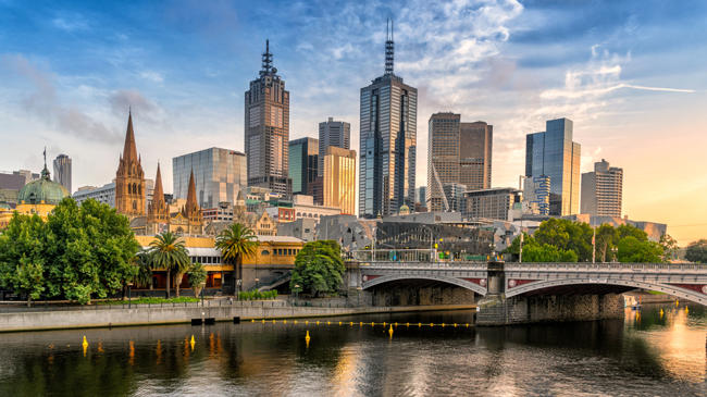 a city skyline with a bridge over a river