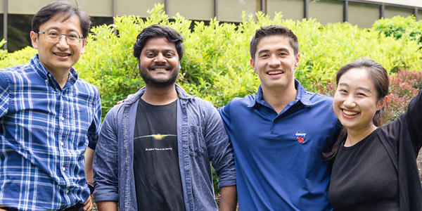 two men standing together smiling