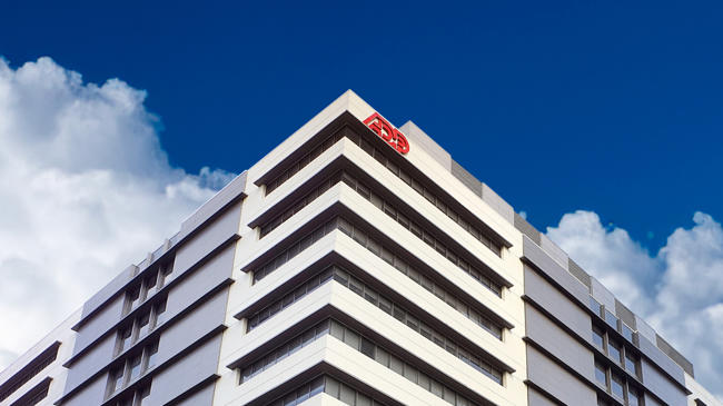 a building with a blue sky and clouds
